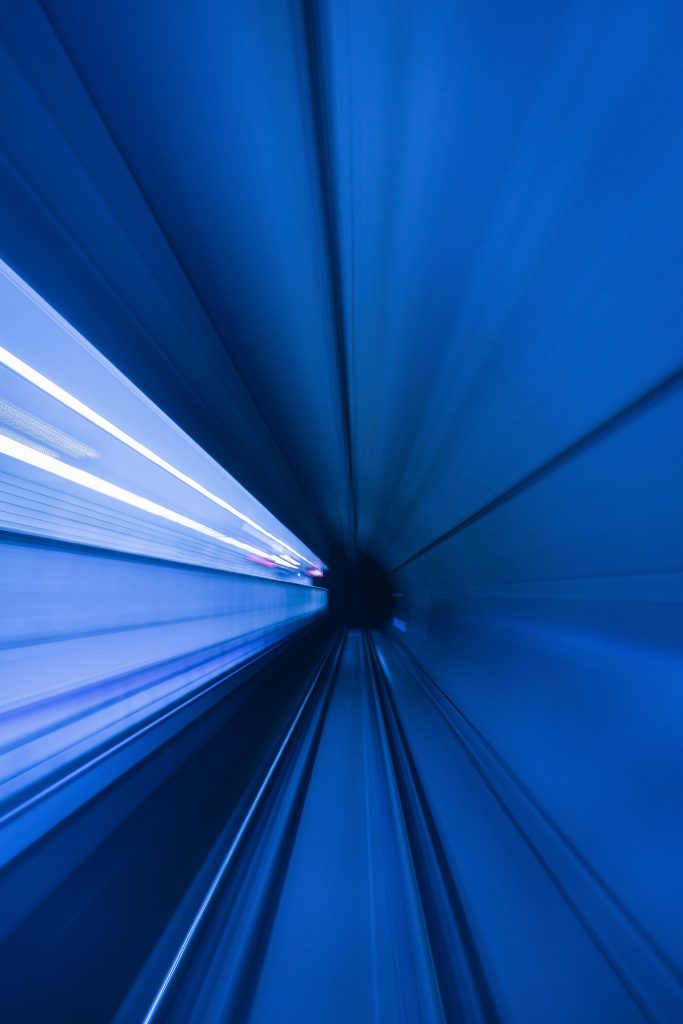 pexels-photo-12707785-12707785 Dynamic motion blur of a blue tunnel creates a captivating futuristic illusion.